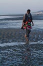 Top model in poncho walking on sandy strange beach Royalty Free Stock Photo