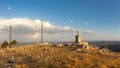 A transmission tower and the summit stone on Mount Ardal in the evening sun. Royalty Free Stock Photo