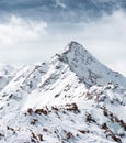 The top of the mountain against the cloudy sky. Alpine landscape Royalty Free Stock Photo