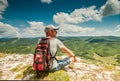 On the top of mountain. Man with backpack enjoyed with mountain