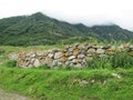 At the top of the mountain there is a descending fog on a beautiful stone texture. An old stone wall in the mountains made of larg