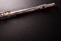 Top and mouthpiece of tansverse flute on black table top