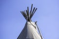 Top of Native American wigwam lodge or teepee tent against clear blue sky background Royalty Free Stock Photo
