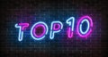 Top 10 neon blue and pink light text on empty red brick wall banner. Bright sign of top ten list winners at night. Design template Royalty Free Stock Photo