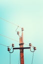 Top old electrical pillar on a background of the blue sky Royalty Free Stock Photo