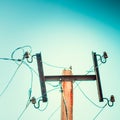 Top old electrical pillar on a background of the blue sky Royalty Free Stock Photo