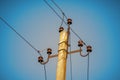 Top of an old electrical pole with plugs and wires on a blue sky background Royalty Free Stock Photo