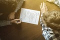 Top overhead directly above view of employee hiring person and examine the resume on the office table