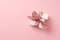 Top panoramic view photo of valentine`s day decorations white giftbox with pink satin ribbon bow on isolated pastel pink Royalty Free Stock Photo