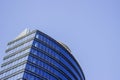 Top part of a blue modern corporate high-rise building with a striped design. Royalty Free Stock Photo