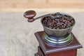 Top part of coffee grinder full of roasted coffee beans