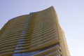 Side view of the top part of a modern corporate building with yellowish overhangs in each floor. Royalty Free Stock Photo