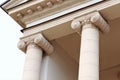 Top part of a newly restored old beige building with columns