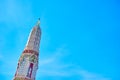 The top part of white corner  prang of Wat Arun complex with colorful porcelain decorations, Bangkok, Thailand Royalty Free Stock Photo