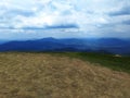 The top of the peak in summer. Mountain ranges on the horizon. Green mountain landscape. Royalty Free Stock Photo