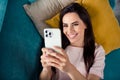 Top photo of positive young lady lying divan at home using gadget video call blog followers listen talk Royalty Free Stock Photo