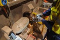 Top picture of miner worker wearing a safety glove eyes protection while using table grinding wheel