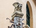 The top of the pillar next to the smithy, decorated with gargoyles and studded with various forging items in Sibiu city in Romania