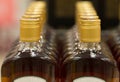 Top of plastic bottles with cognac or brandy standing in the liquor store. From the front. Royalty Free Stock Photo