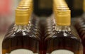 Top of plastic bottles with cognac or brandy standing in the liquor store. From the front. Royalty Free Stock Photo