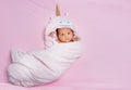 Newborn baby girl wrapped in unicorn pink towel from above Royalty Free Stock Photo