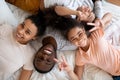 Top portrait of smiling african family of four on bed Royalty Free Stock Photo