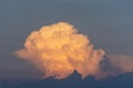 The top of a powerful thundercloud at sunset summer sky