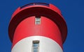 TOP OF RED AND WHITE LIGHTHOUSE IN SUNLIGHT Royalty Free Stock Photo