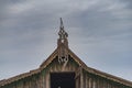 Top ridge, siding and gable beautiful carved platbands on the roof of a wooden house rustic old sky Royalty Free Stock Photo