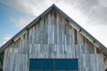 Top roof of old weathered wooden barn against dramatic sky Royalty Free Stock Photo