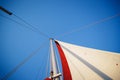 Top of the sailboat, mast head, sail and nautical rope yacht detail. Yachting, marine background Royalty Free Stock Photo