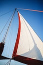 Top of the sailboat, mast head, sail and nautical rope yacht detail. Yachting, marine background Royalty Free Stock Photo
