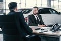 Top sales manager and customer at dealership showroom Royalty Free Stock Photo