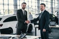 Top sales manager and customer at dealership showroom Royalty Free Stock Photo