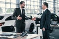 Top sales manager and customer at dealership showroom Royalty Free Stock Photo