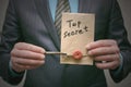 Top secret concept. Top secret documents or message and a decryption key in businessman hands. Royalty Free Stock Photo