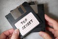 Top secret information on retro vintage floppy disk magnetic computer among shredder paper, thief information concept