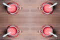 A top shallow dof view of a watermelon smoothies in a mason jars with tubes on wooden background