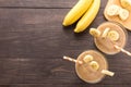 Top shot banana smoothie on wooden background Royalty Free Stock Photo