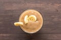 Top shot banana smoothie on wooden background Royalty Free Stock Photo