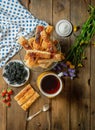 Top shot of Cinnamon French Toast Sticks in a bowl with blackberries in a plate and cup of tea syrup