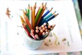 Top shot, close up of different, used, blunt, dull and sharpened colored pencils on bright papers background, space for text, Royalty Free Stock Photo