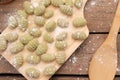 Top shot of Gnocchis on a wooden dock with flour on them