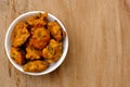 Top shot of Indian snack pakora on wooden background with copy space Royalty Free Stock Photo