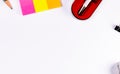 Top shot of multi colored sticky notes with a pencil, paper waste, ball pen in case and one black binder clip Royalty Free Stock Photo