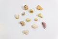 Top shot of several random positioned colorful stones that collected from beach on white background Royalty Free Stock Photo