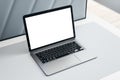 Top side view on modern laptop with blank white screen with place for your logo or text on light grey table surface. 3D rendering