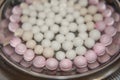 Top side view of red and white tangyuan tang yuan, glutinous rice dumpling balls in steel bowl.
