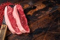 Top sirloin beef steak or brazilian Picanha, raw meat on butcher cleaver. Wooden background. Top view. Copy space Royalty Free Stock Photo