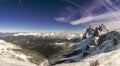 Top of snow-capped Seceda mountain in the Italian Dolomites in sunny weather with blue sky and clouds. The lens reflexes are also Royalty Free Stock Photo